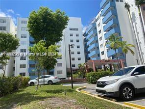 a front view of a residential apartment building with a yard