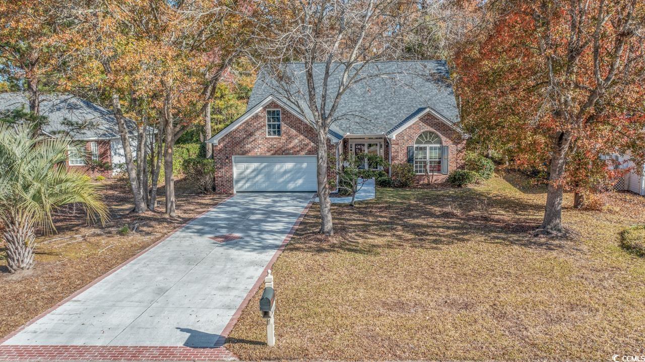 View of front of property featuring a garage and a