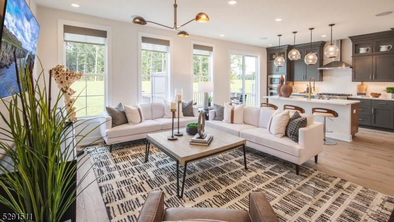 a living room with furniture fireplace and a large window