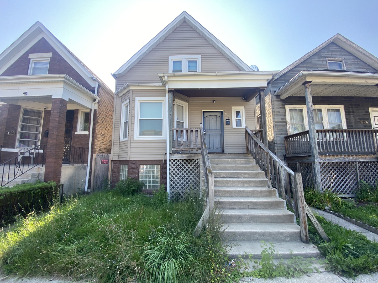 a view of a house with a yard and stairs