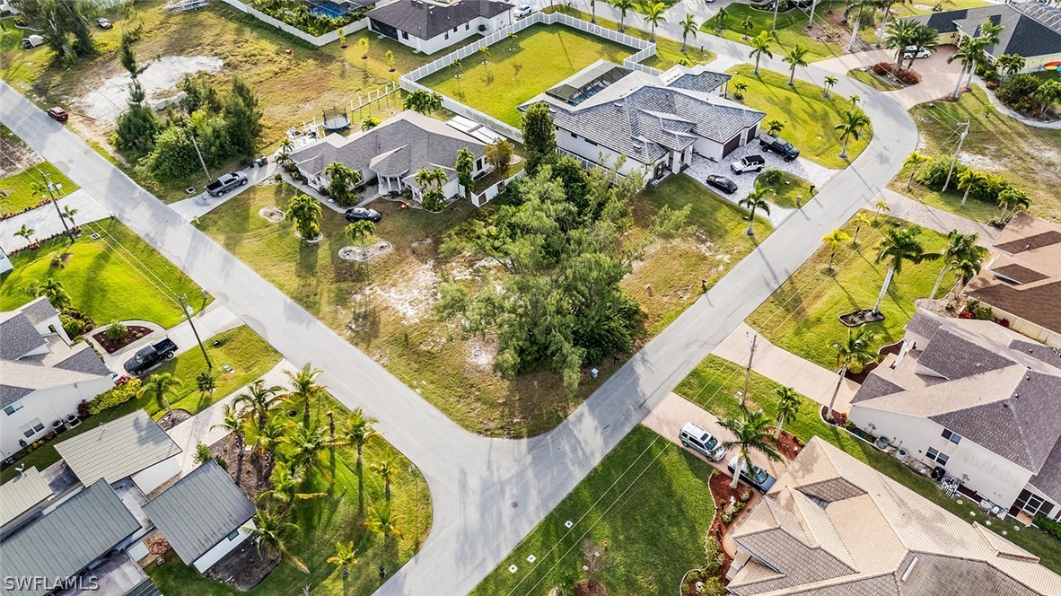 an aerial view of a house with a swimming pool and outdoor seating