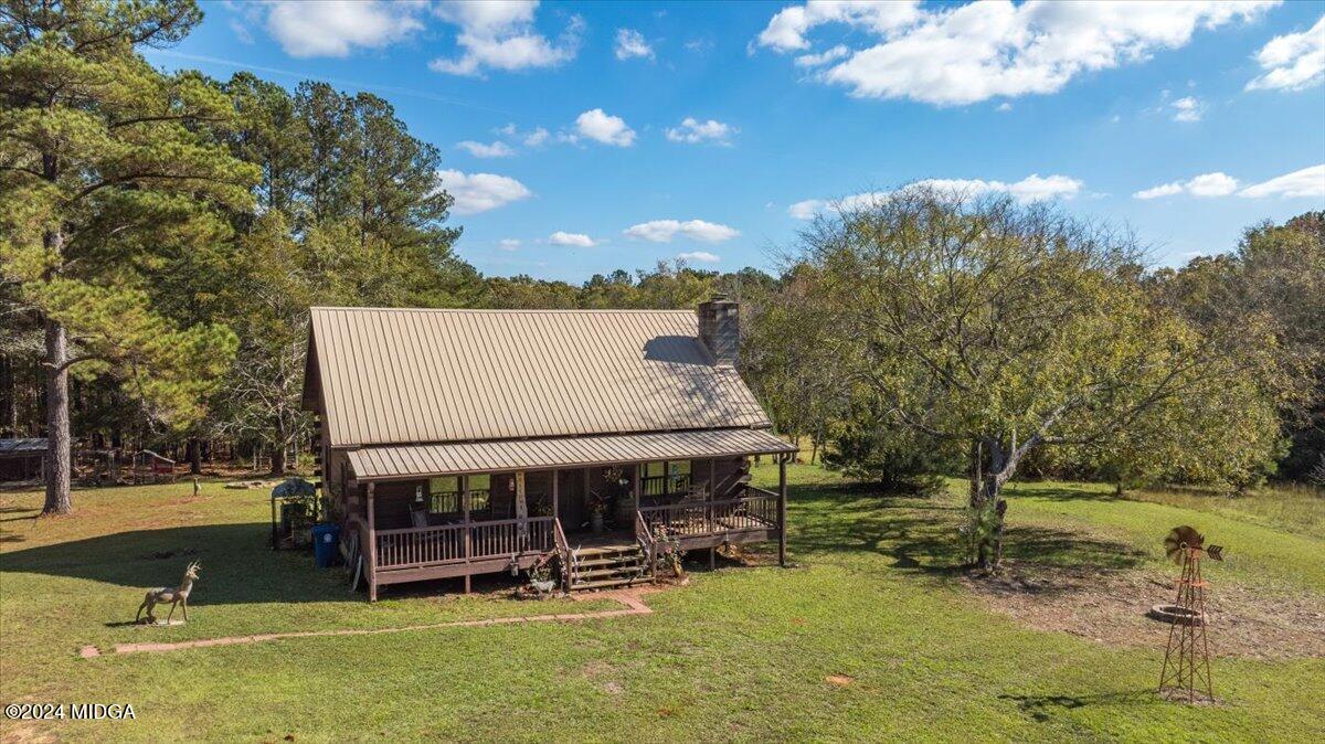 a view of a house with backyard porch and sitting area