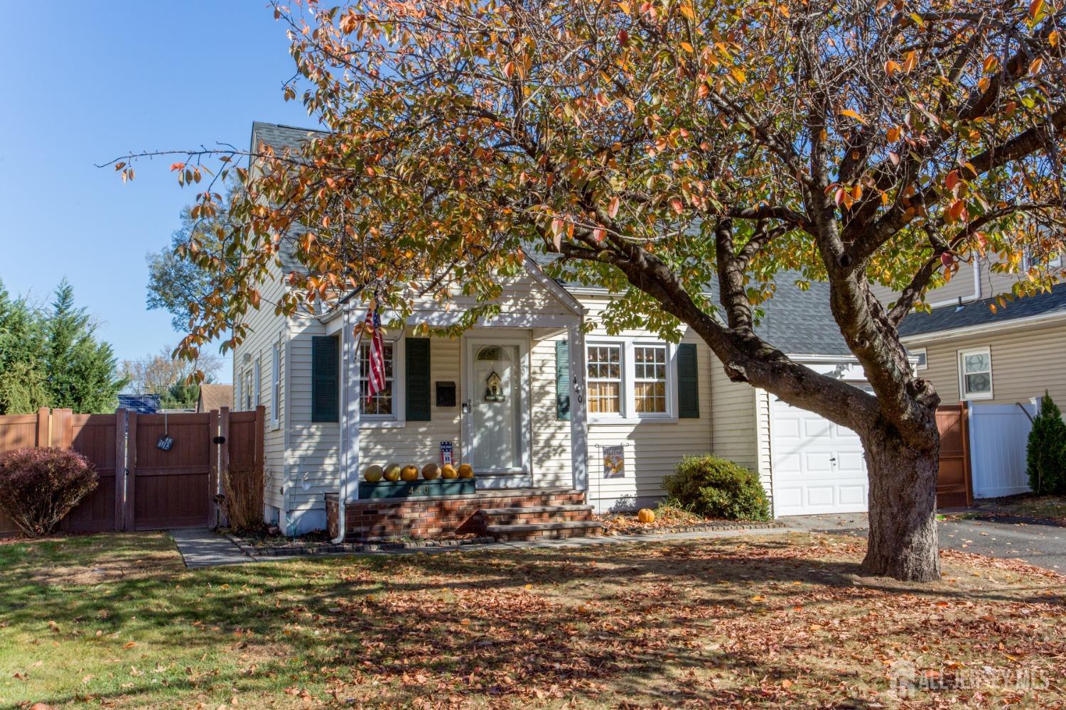 a view of a house with a tree in the background