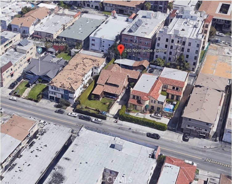 an aerial view of a residential apartment building with parking