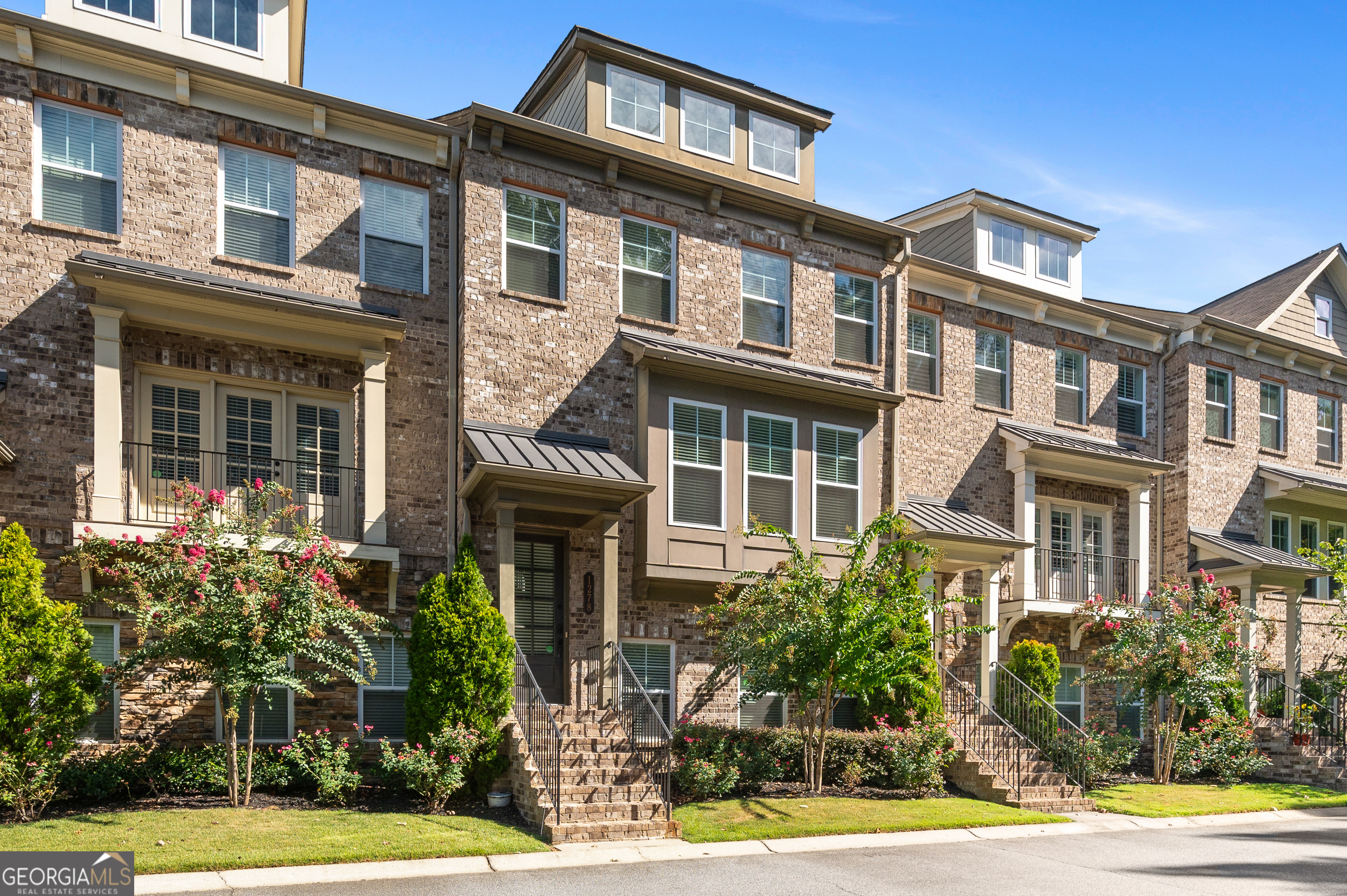 a front view of a residential apartment building with a yard