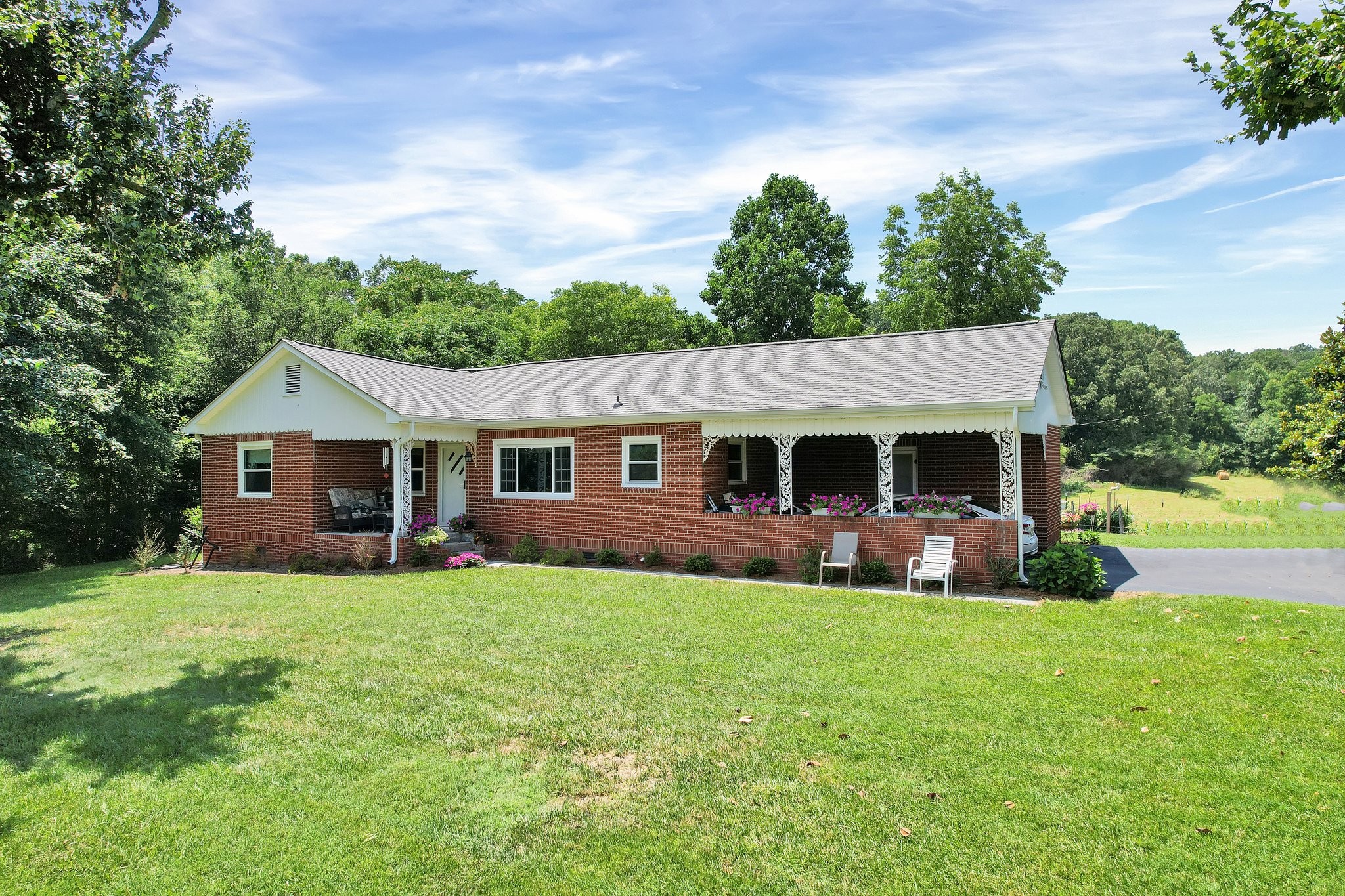 a view of a house with a yard and sitting area