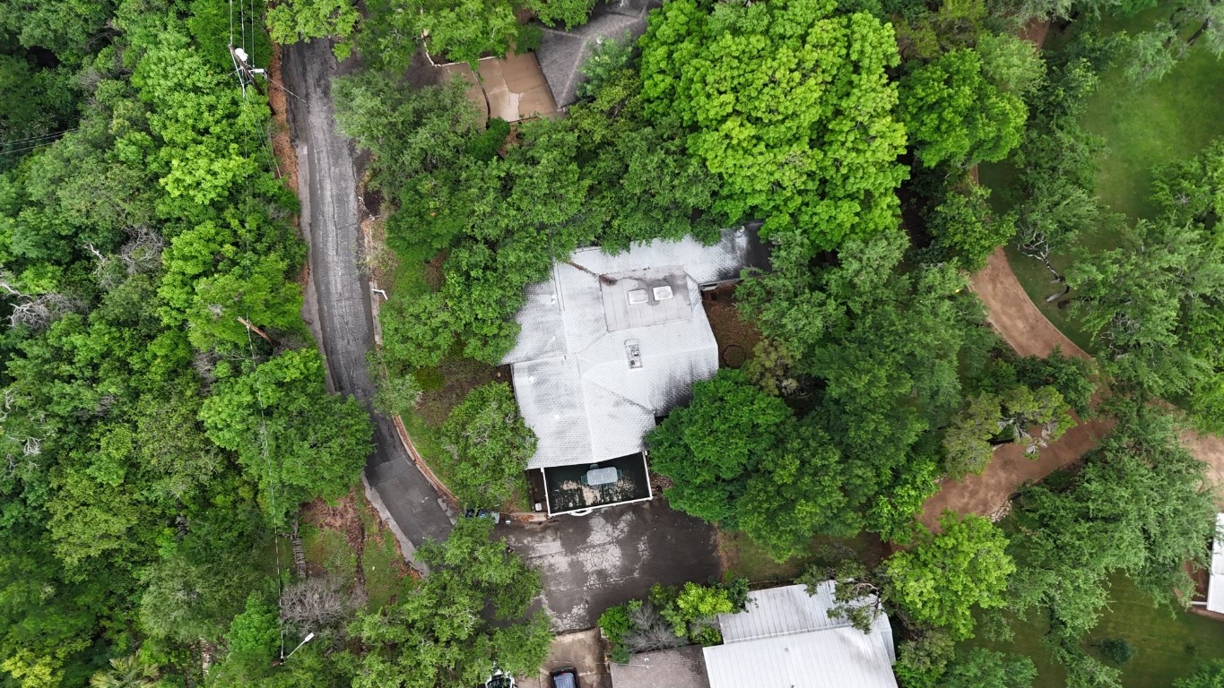 an aerial view of a house with outdoor space and street view