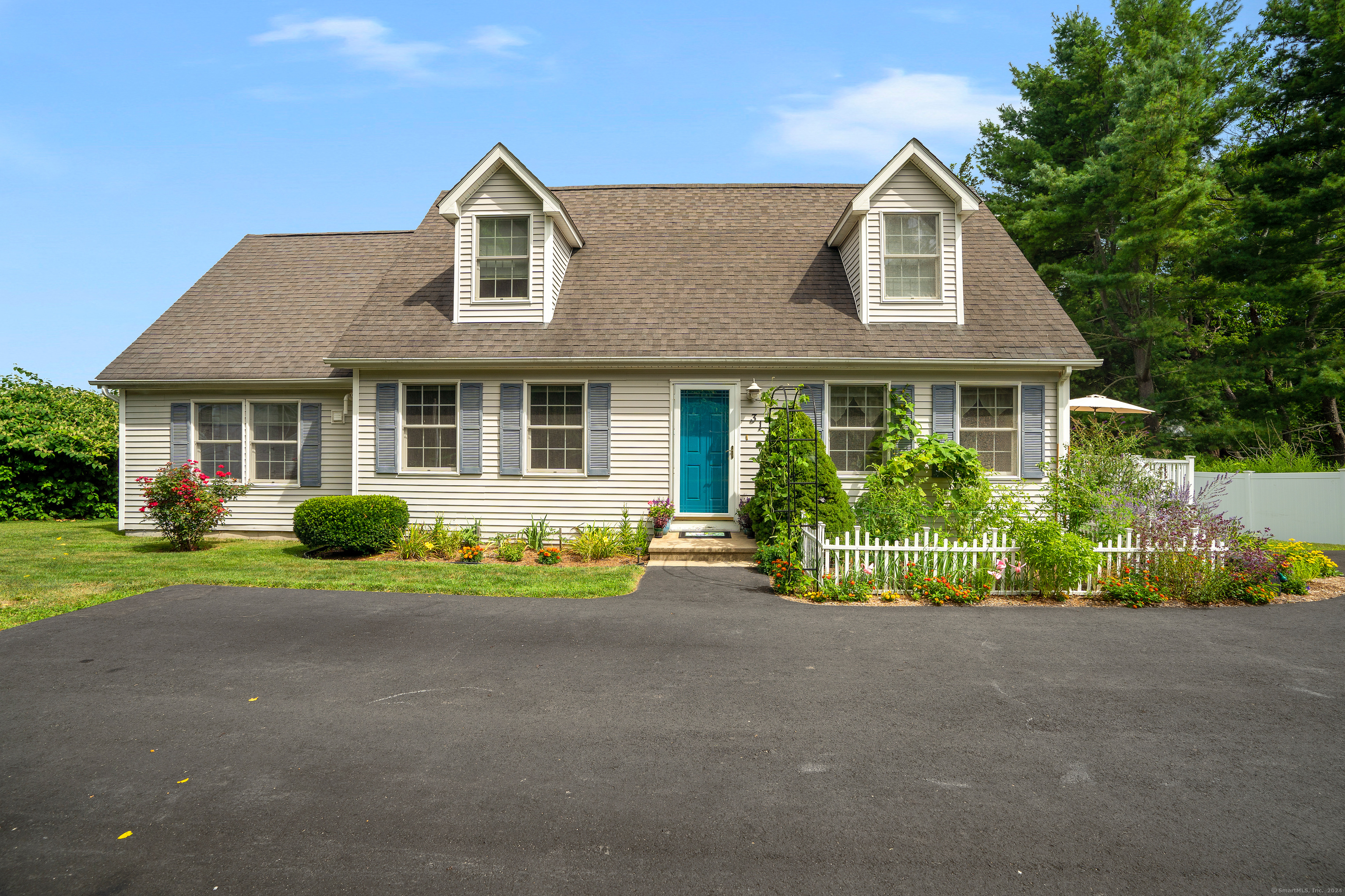 a front view of a house with a garden