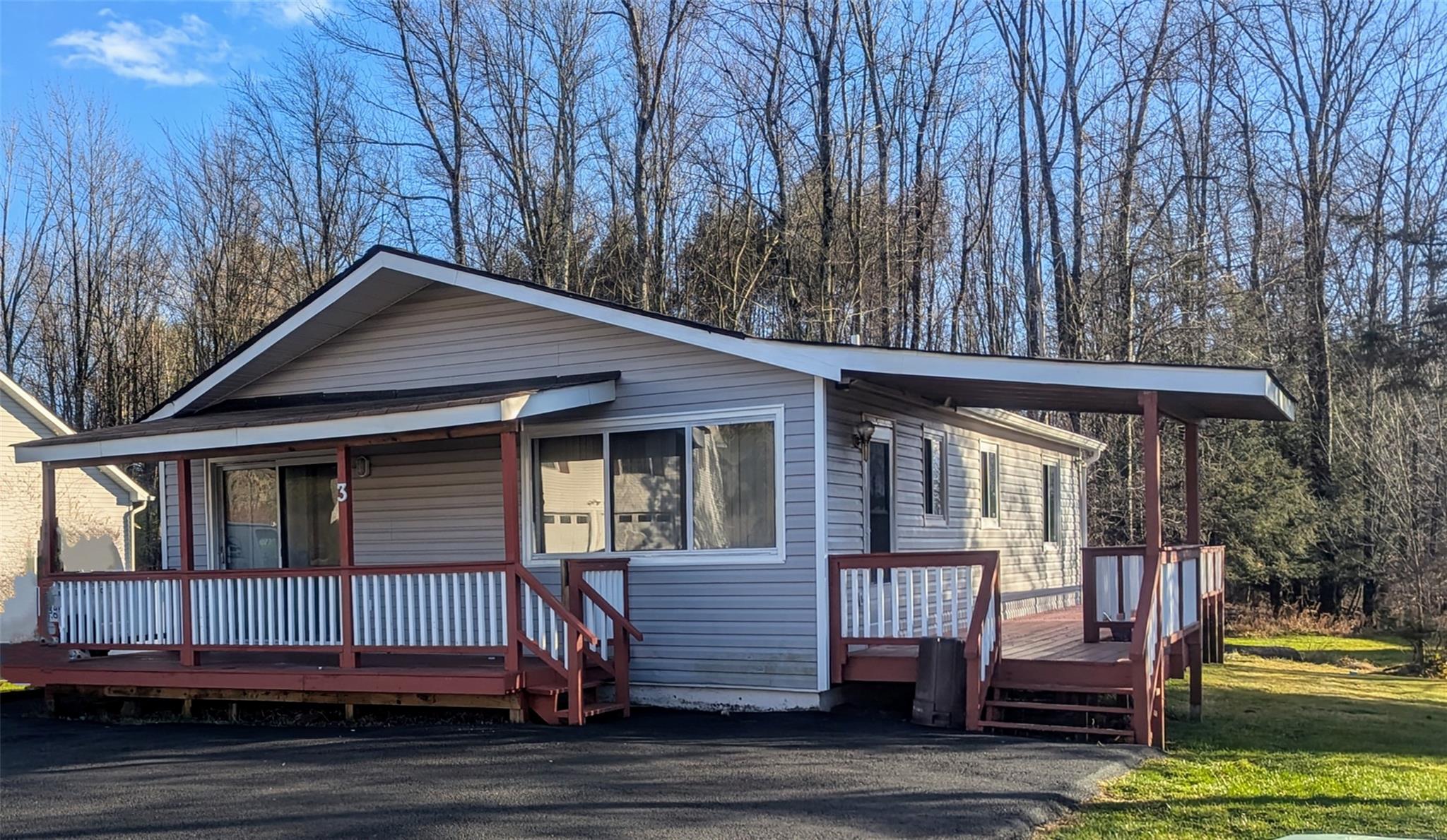 View of front facade featuring a front lawn and covered porch