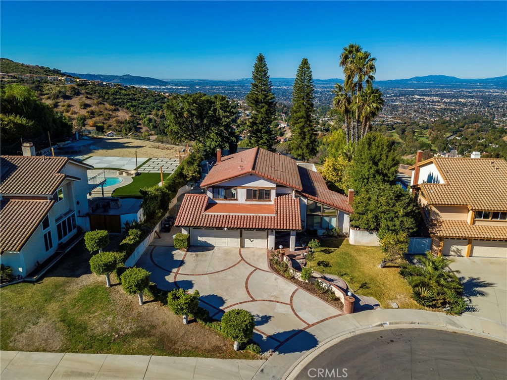 a aerial view of a house with a garden and lake view