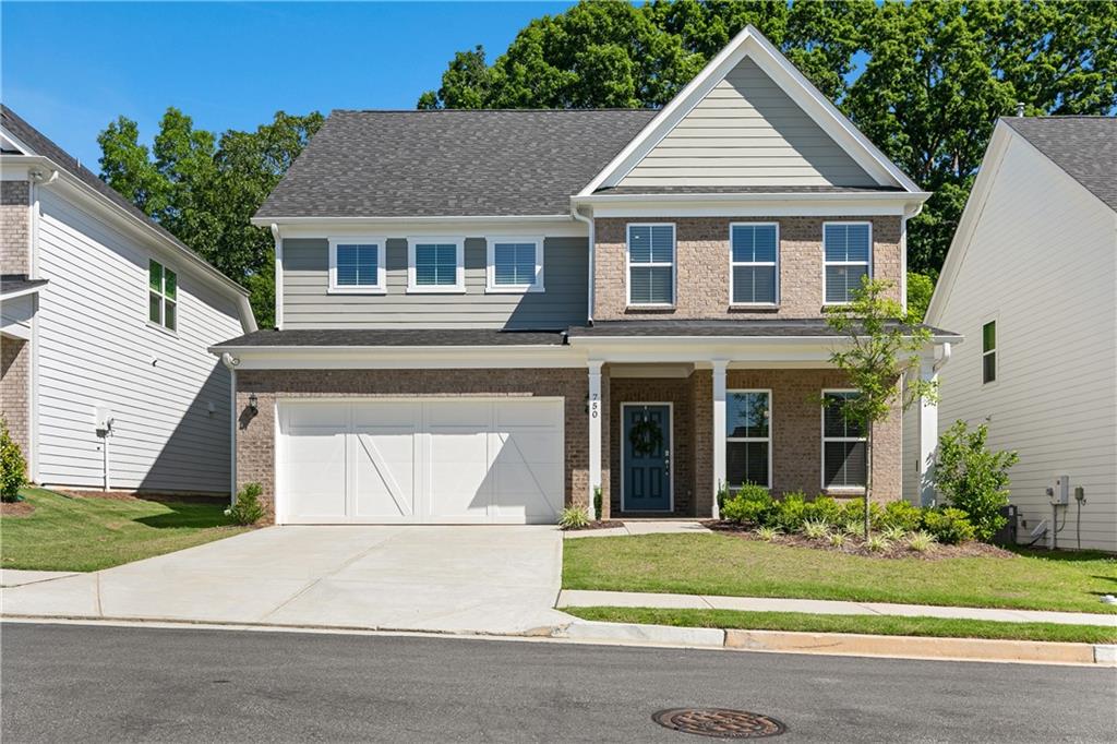 a front view of a house with a yard and garage