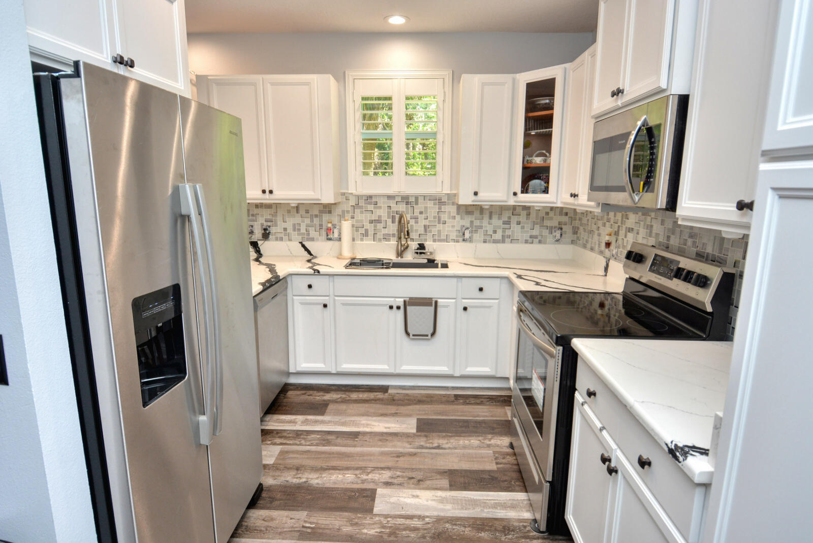 a kitchen with a sink stove and refrigerator