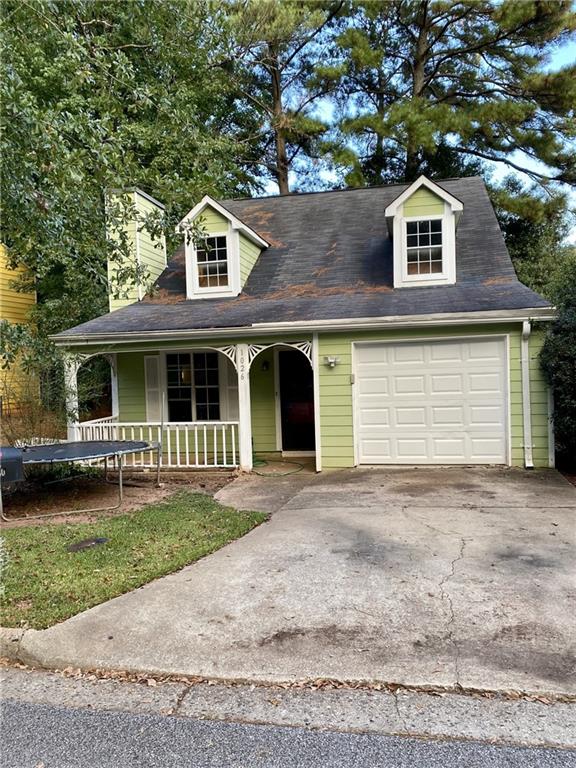 a front view of a house with a garden and yard