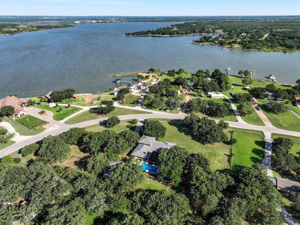 an aerial view of a houses with a lake view