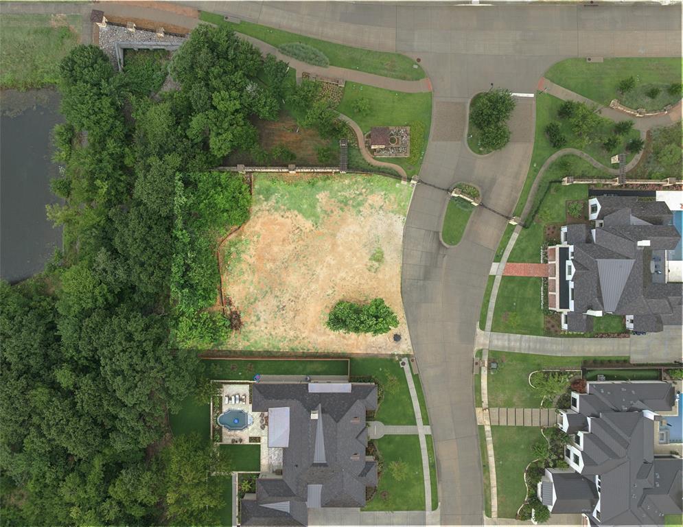 an aerial view of a residential houses with outdoor space and street view