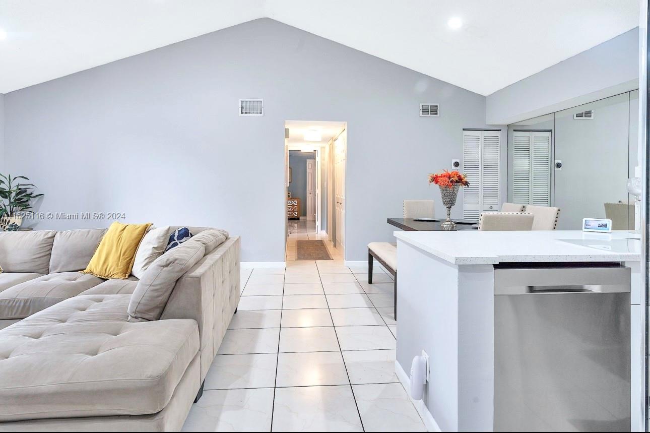 a living room with a sink and a mirror