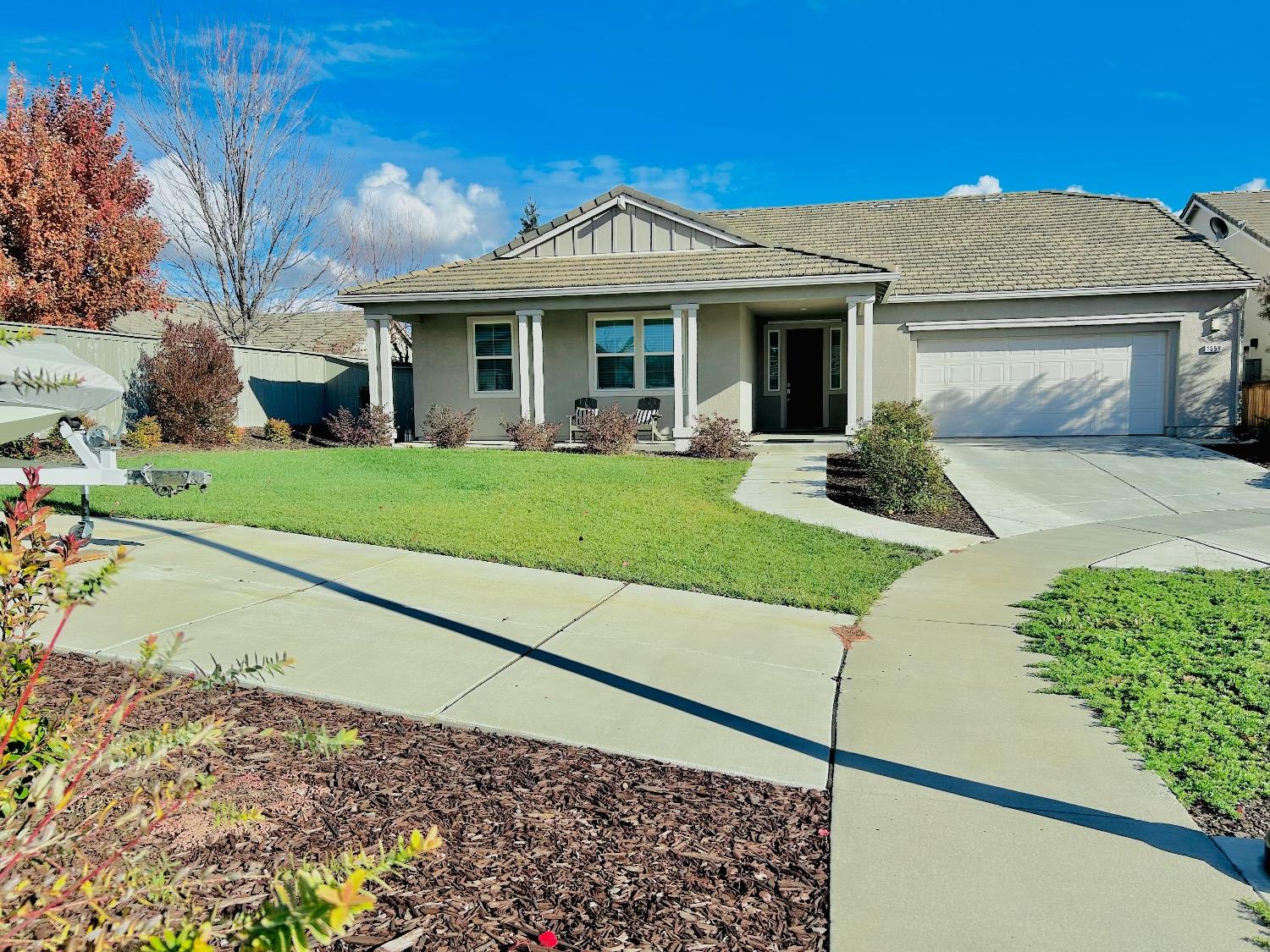 a front view of a house with a yard and porch