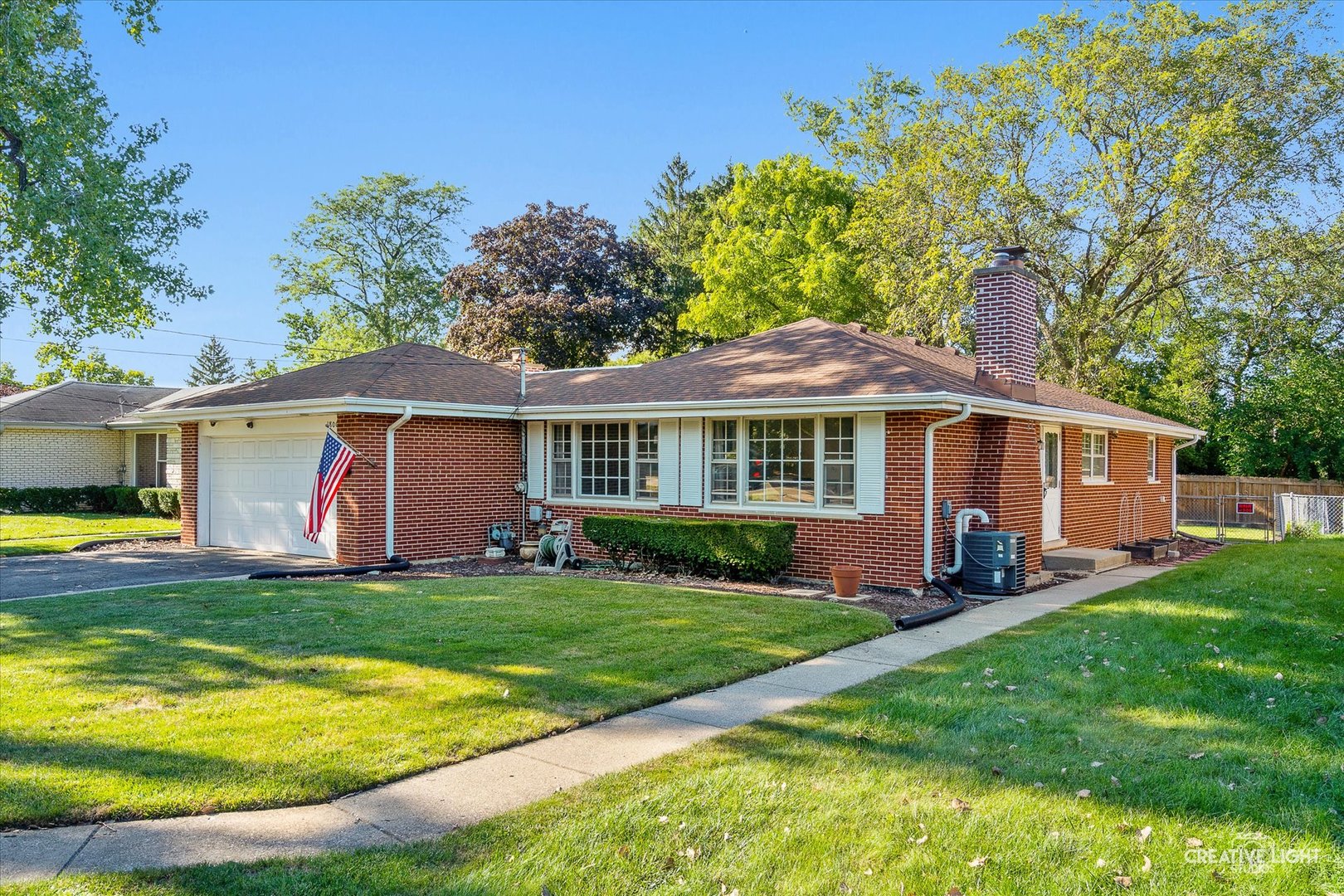 a front view of a house with a yard porch and patio