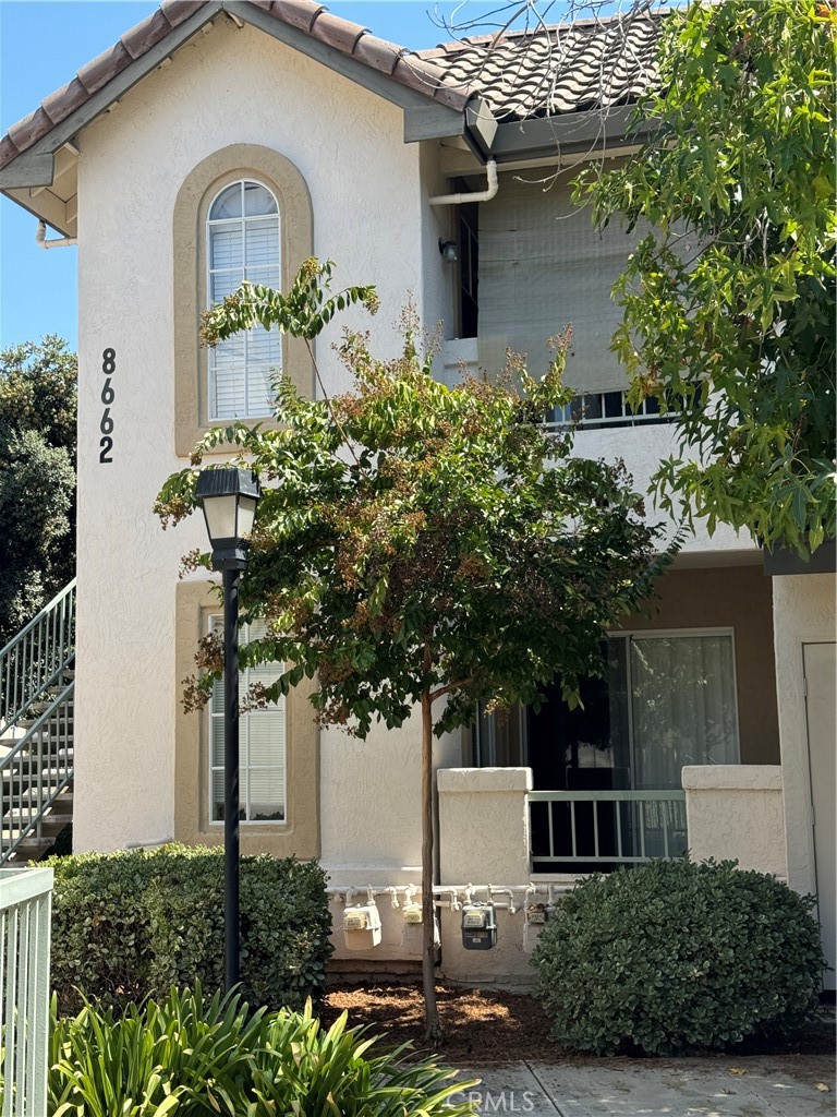 a front view of a house with garden