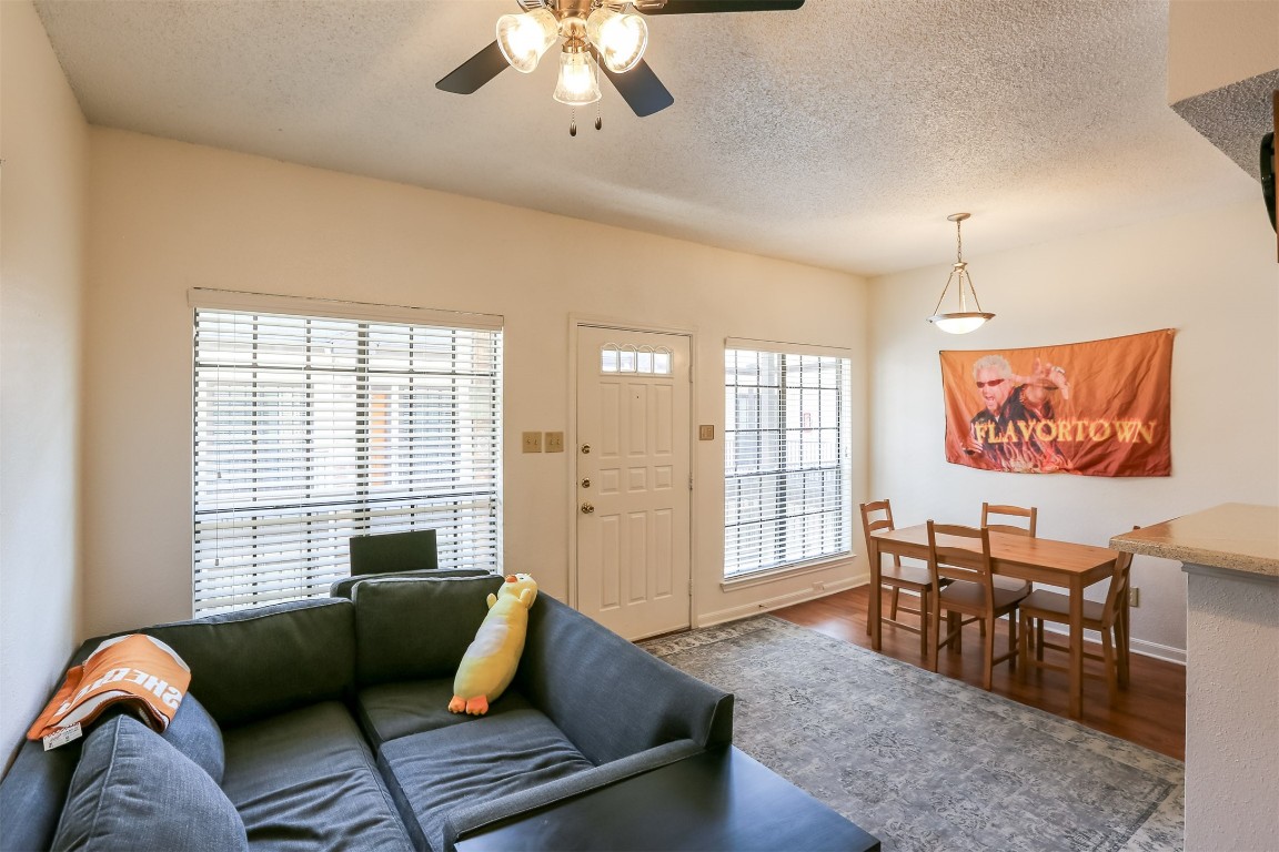 a living room with furniture and wooden floor