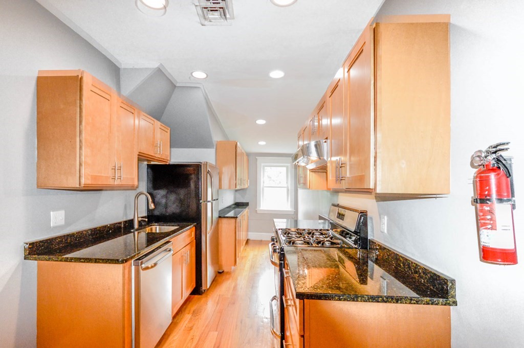 a kitchen with a sink a stove and a cabinets