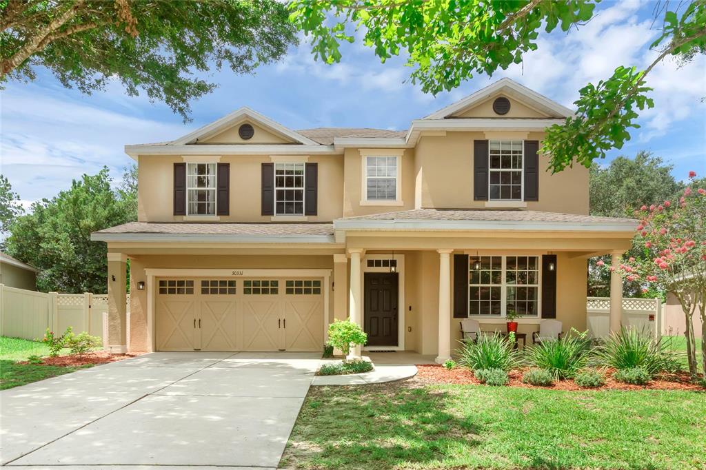 a front view of a house with a yard and garage