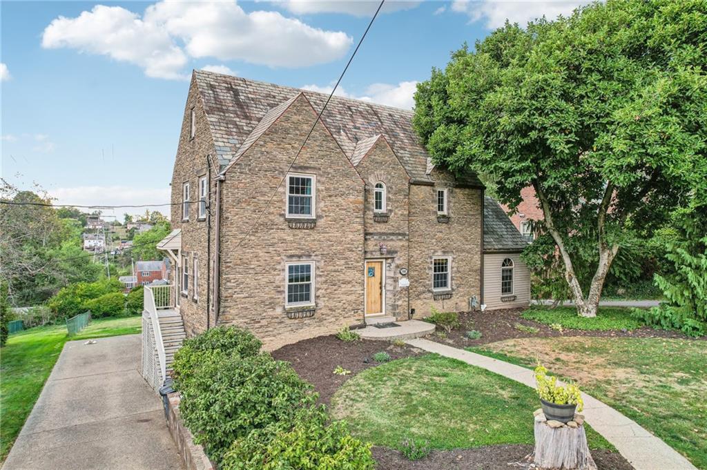 a front view of a house with garden