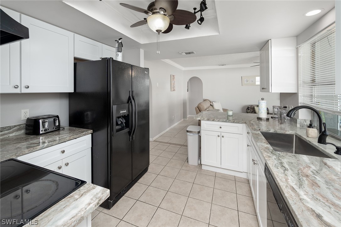 a kitchen with a sink cabinets and stainless steel appliances