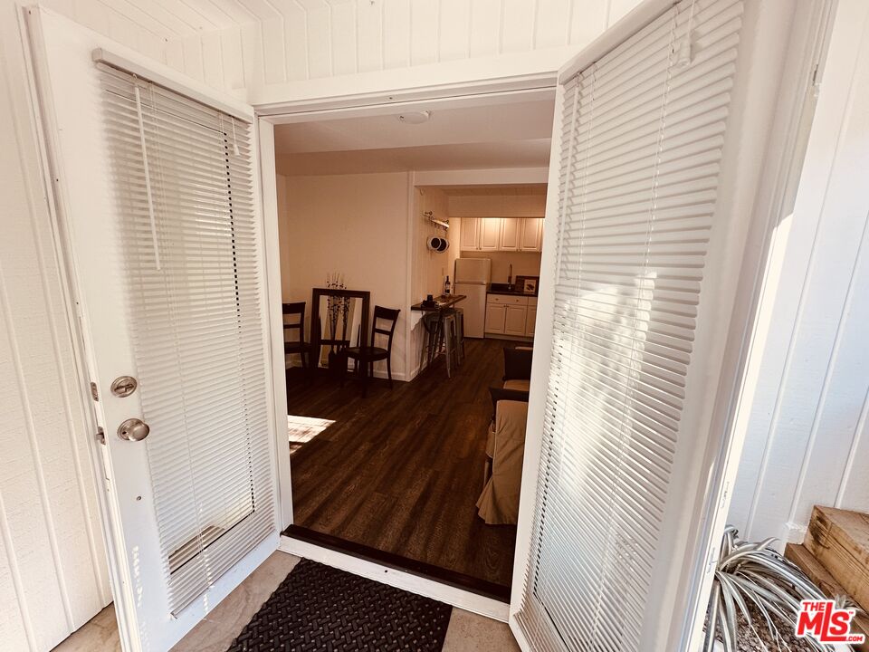 a view of a room with wooden floor and furniture