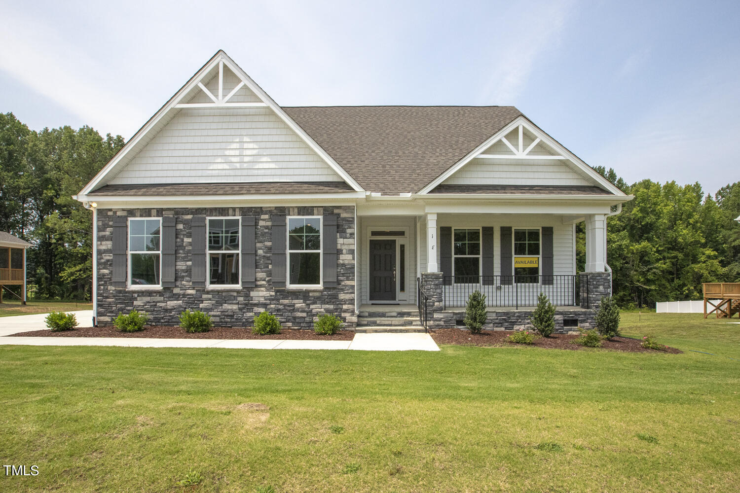 a front view of a house with a garden and patio