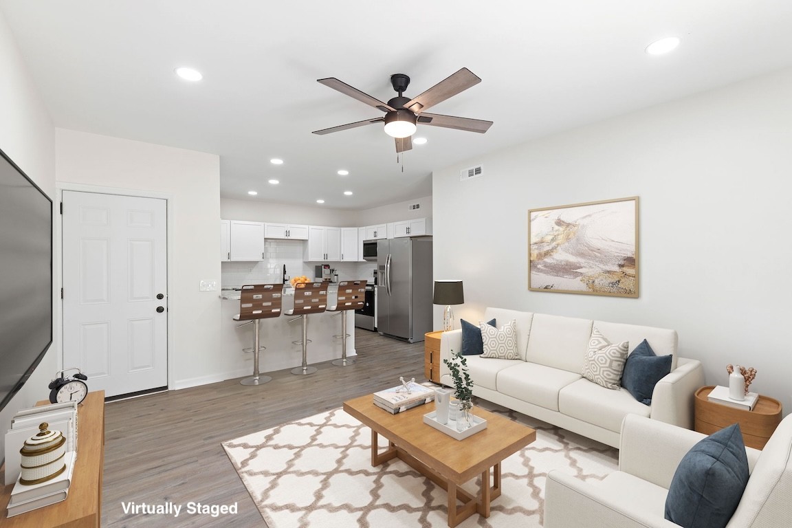 a living room with furniture and kitchen view