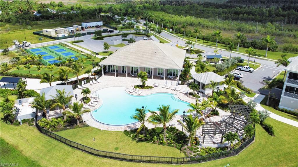 a view of a swimming pool with a yard and plants