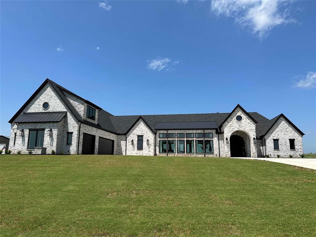 a big house with a big yard and large trees