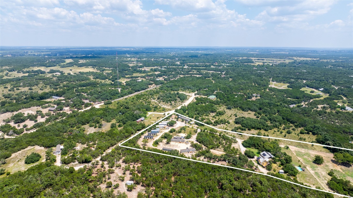 an aerial view of city lake and trees