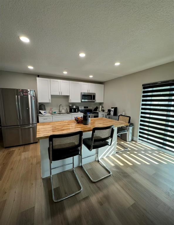 a kitchen with stainless steel appliances kitchen island granite countertop a sink and cabinets