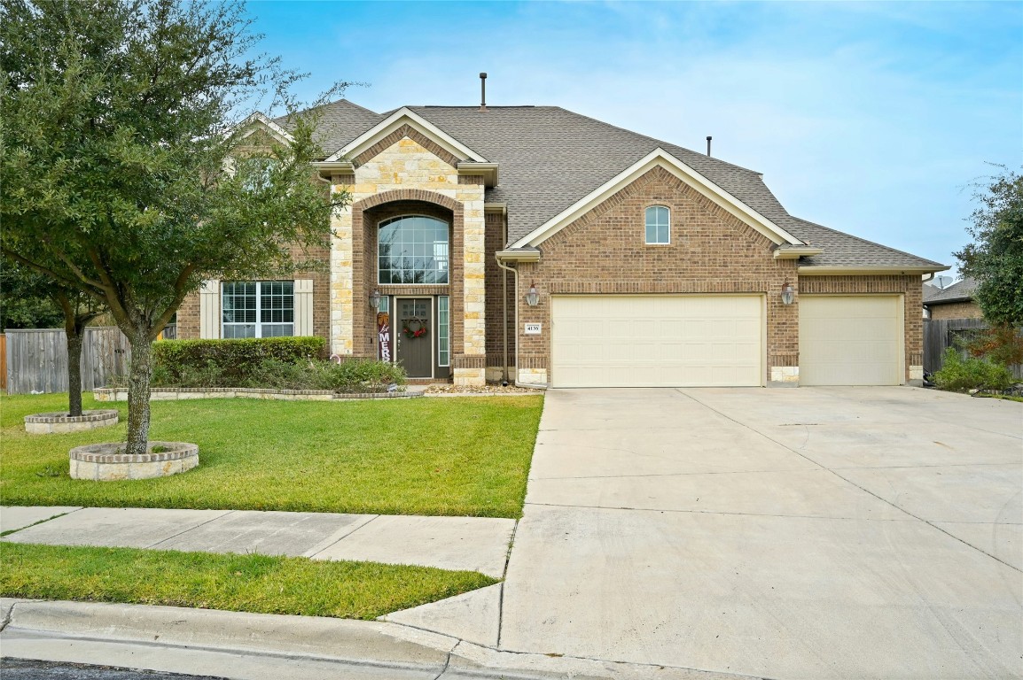 a front view of a house with a garden and plants