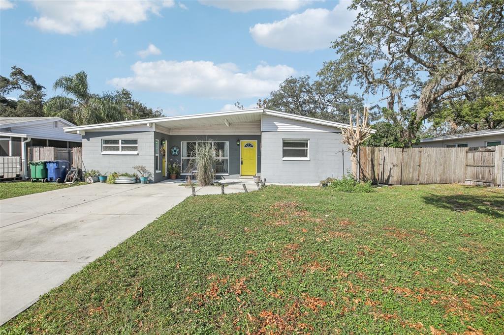 a front view of house with yard and green space