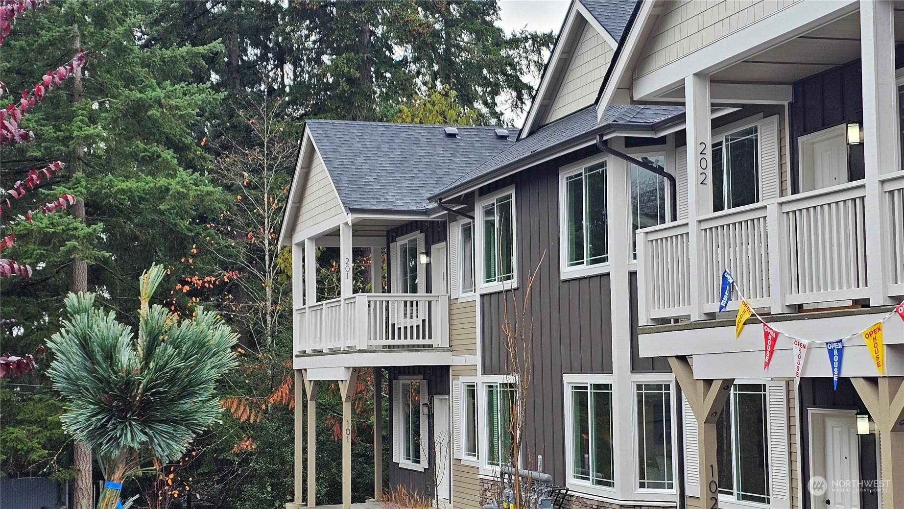 a front view of a house with balcony and garden