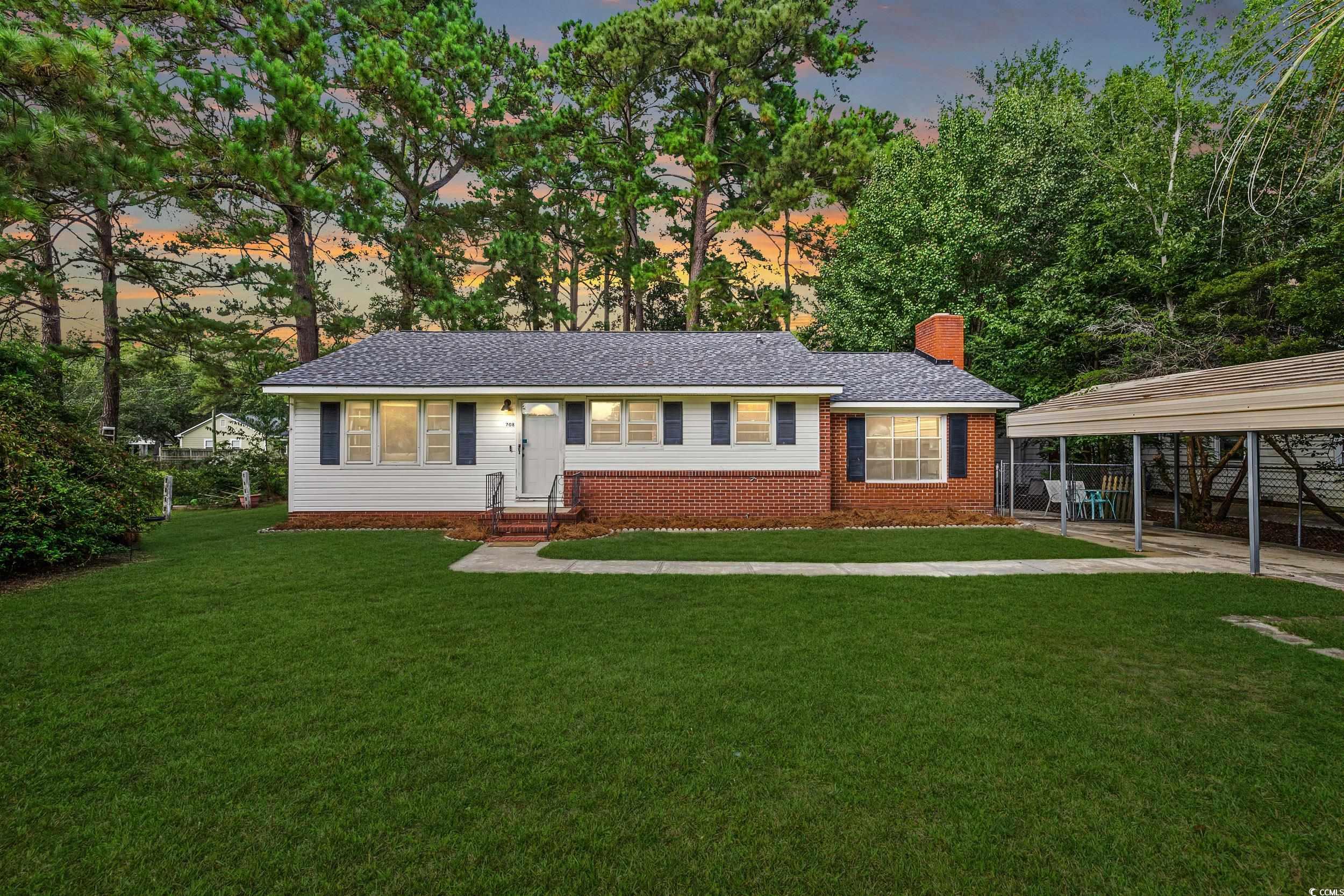 Ranch-style home featuring a yard