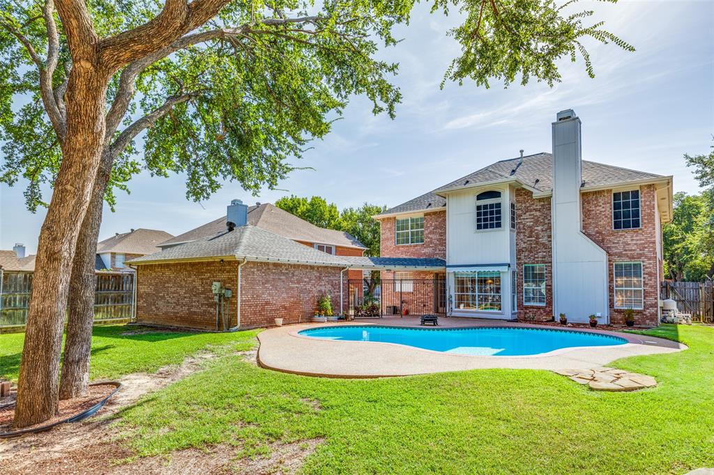 a view of a house with a swimming pool and a yard