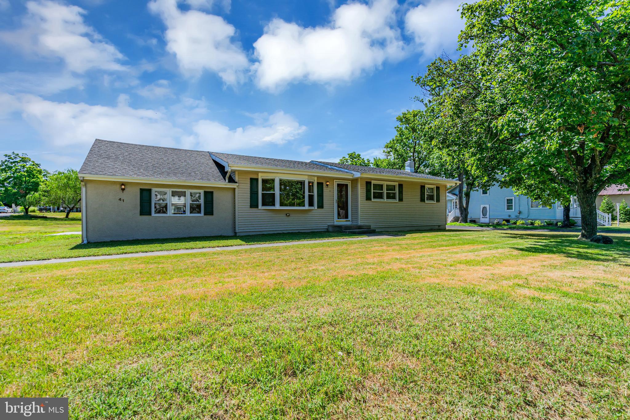 a view of a house with a backyard