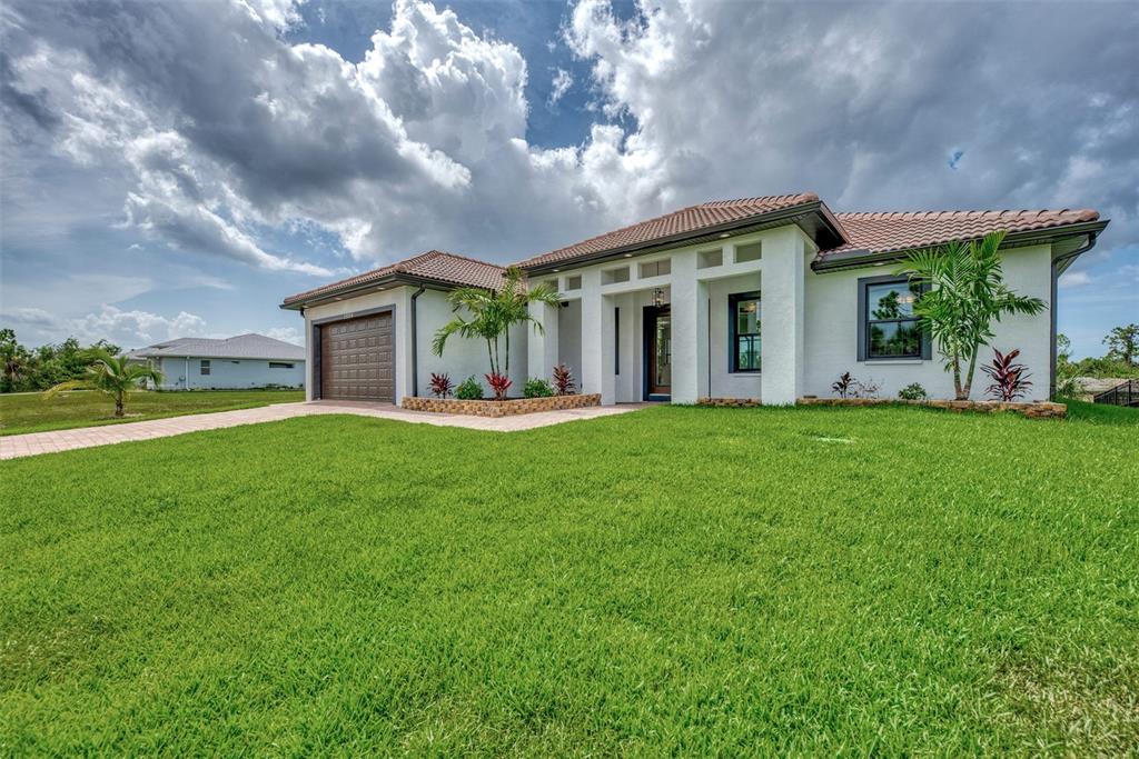 a front view of house with yard and outdoor seating