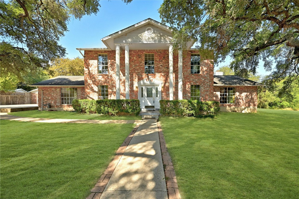 a front view of a house with garden