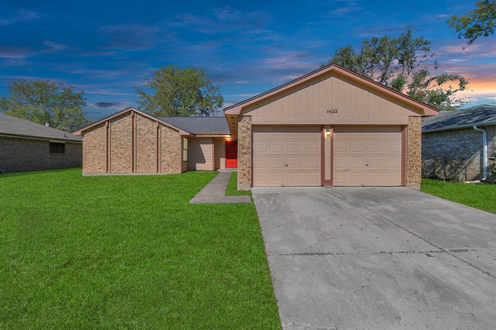 a view of a house with a yard and garage