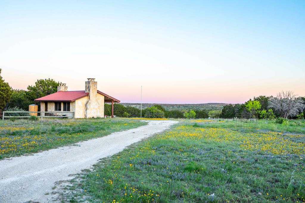 a view of a house with a yard and sitting area