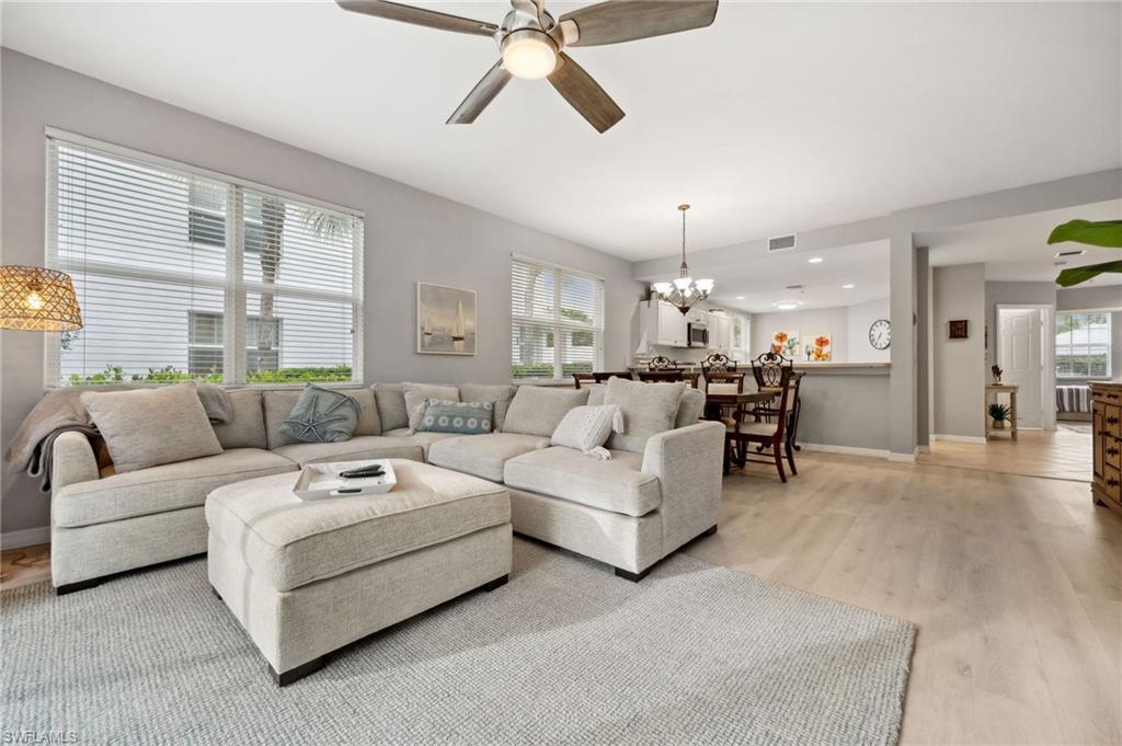 a living room with furniture and a chandelier