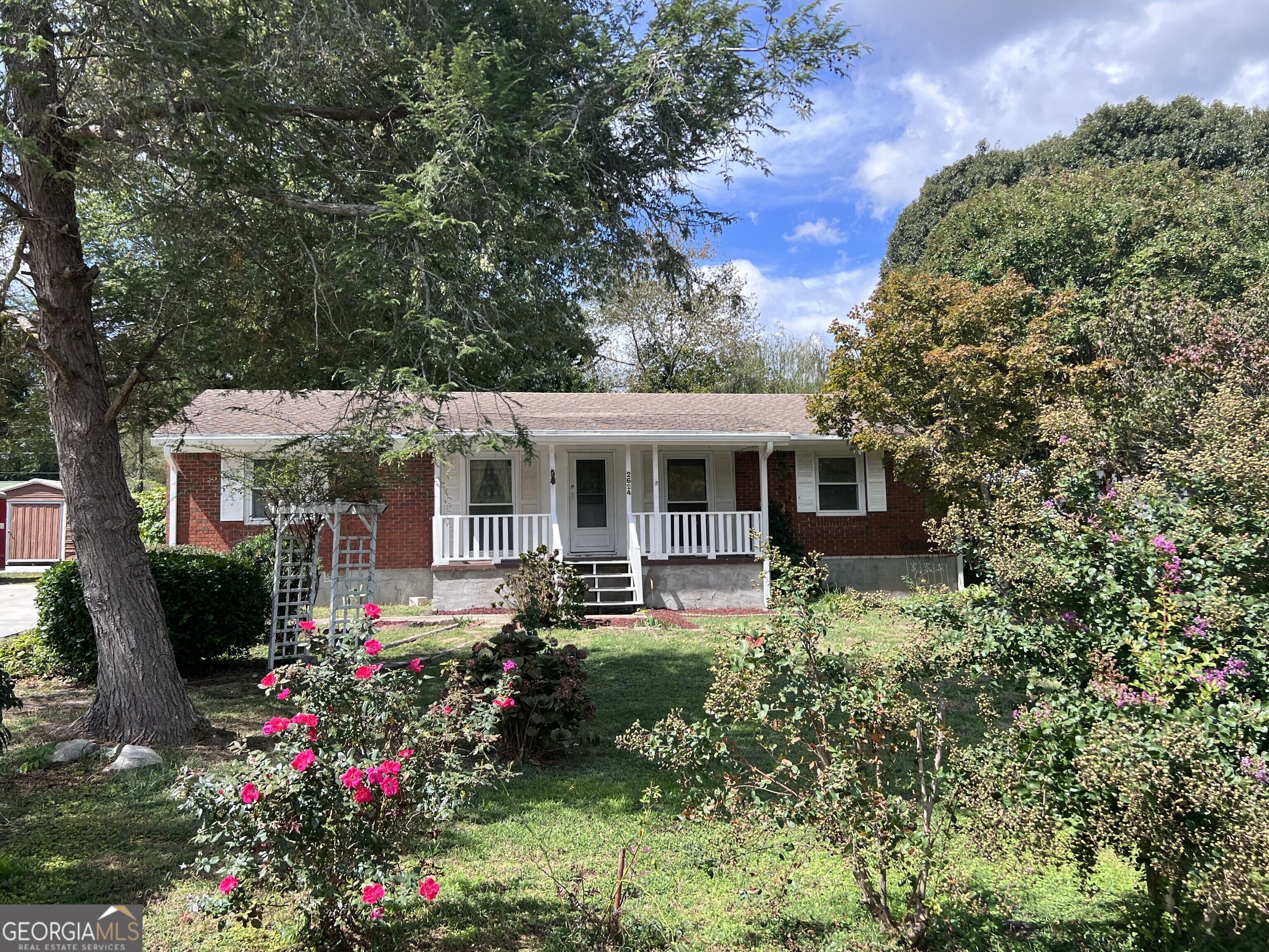 a front view of house with yard and outdoor seating