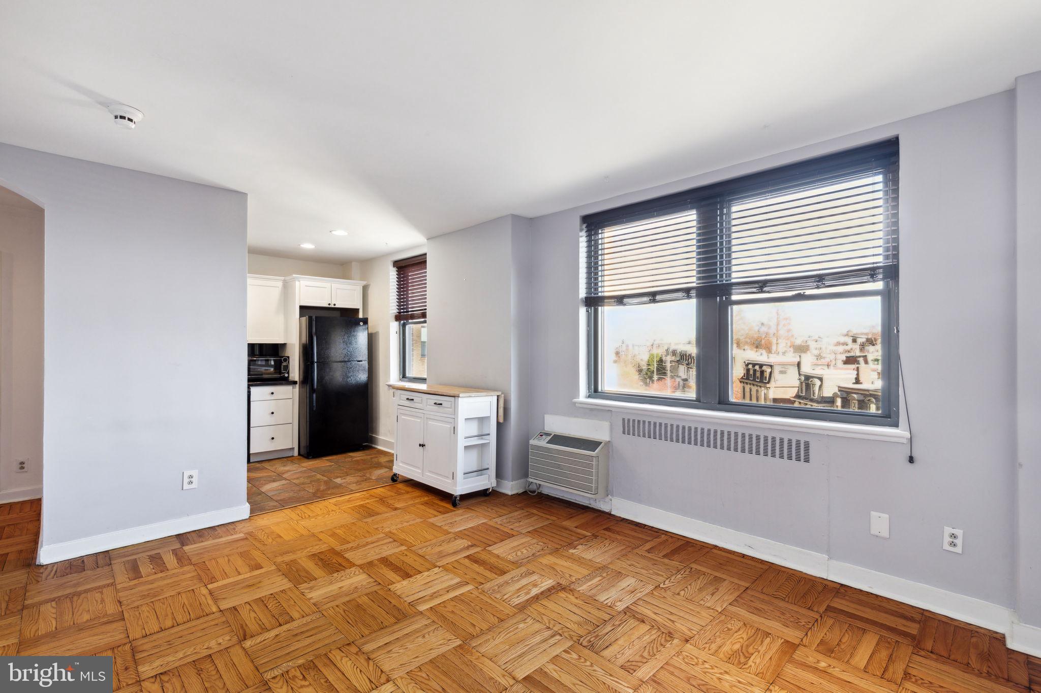 a view of kitchen with windows and refrigerator