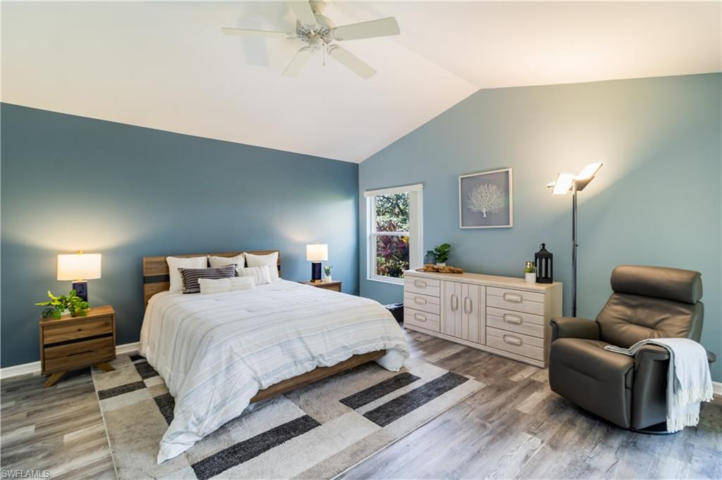 Primary Bedroom featuring vaulted ceiling, ceiling fan, and vinyl plank floors