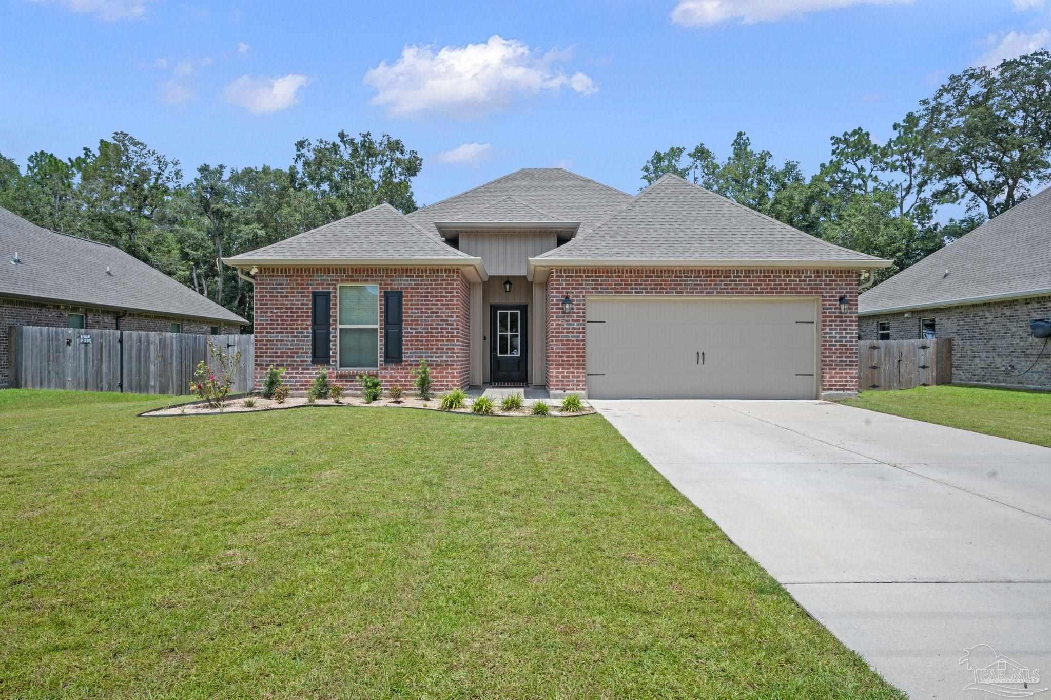 a view of a house with a backyard